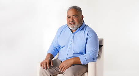 KRYSTEXXA patient Chance smiling in a blue shirt