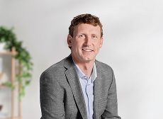 Dr Botson wearing a gray blazer